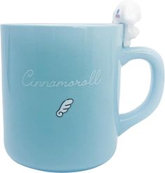 a blue coffee mug with a small white bird on it's side and the word cinnamon written in cursive writing