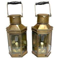 two old fashioned brass lanterns with handles