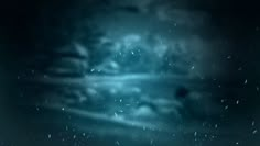 a blurry image of snow falling in the night sky with clouds and stars on it