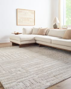 a living room with a white couch and rug