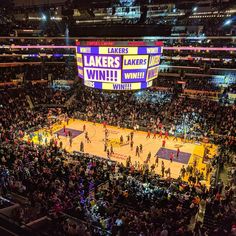 an overhead view of a basketball game in a large arena with people standing on the court