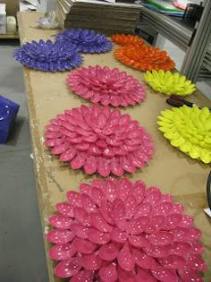 colorful flowers are sitting on the table in front of boxes and other items for sale