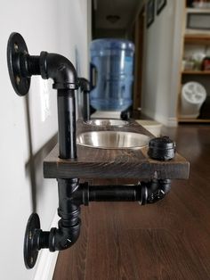 a sink and faucet mounted to the side of a wall in a kitchen