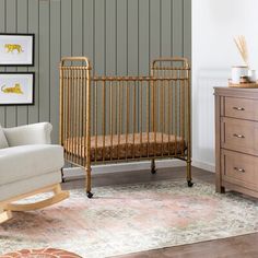 a living room with a couch, chair and baby crib