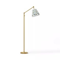 a floor lamp with a white and blue shade on the top, in front of a white background