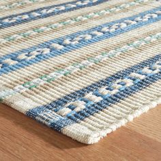 a close up view of a blue and white rug on a wooden floor with wood floors