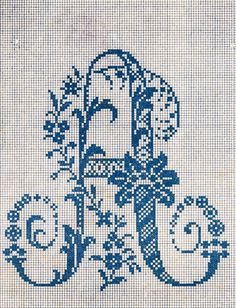 an old fashioned cross stitch pattern with the letter e in it's center and flowers on