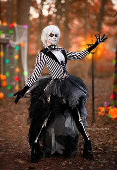 a woman dressed up as a skeleton in the woods