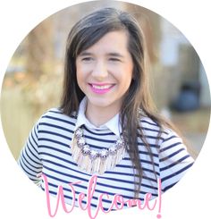 a woman with long hair wearing a striped shirt and necklace smiles at the camera while standing in front of a white circle that says welcome