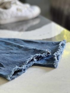 a pair of jeans that have been torn off and are sitting on a counter top