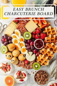 a platter filled with different types of cheeses, fruit and other food items