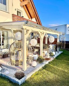 an outdoor patio with chairs and tables in the grass