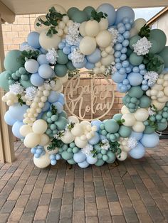 a blue and white balloon arch with the words happy new year on it