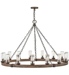 a wooden chandelier with glass cylinders hanging from the ceiling