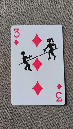 a playing card that has two people on it, one is pulling the other up