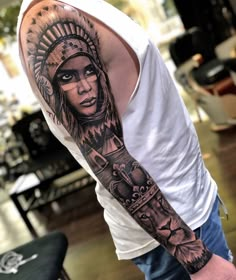 a man with a native american tattoo on his arm