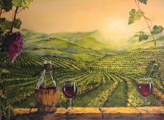 two glasses of wine are sitting on a table in front of a vineyard scene with vines and mountains