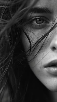 black and white photograph of a woman's face with her hair blowing in the wind