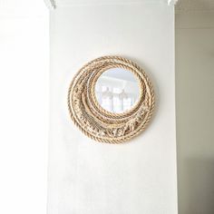 a round rope mirror hanging on the wall