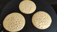 three crackers sitting on top of a black plate