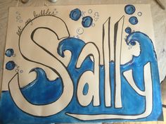 the word salt written in white and blue ink on a piece of paper with scissors