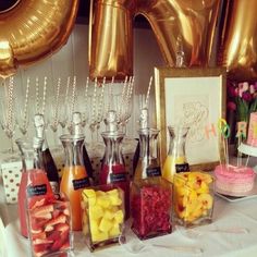 a table topped with lots of food and balloons