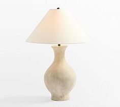 a table lamp with a white shade on it