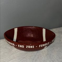 a brown bowl with white stripes and words on the side that says denver - end zone - fubble club