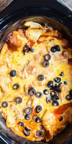 a pizza with olives and cheese in a crock pot