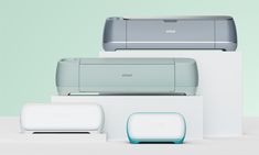 three different types of printers and scanners sitting on top of each other in front of a mint green background