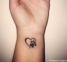 a small paw heart tattoo on the wrist