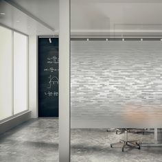 an empty room with a wooden table and chalkboard on the wall in front of it