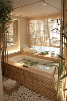 a bathroom with a large jacuzzi tub next to a bamboo plant and window