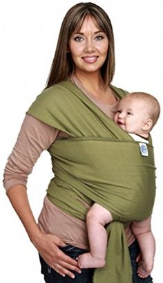 a woman holding a baby in a green wrap