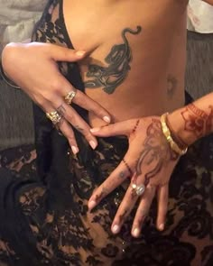 a woman with tattoos on her chest and hands