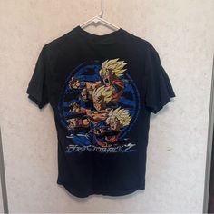 a t - shirt hanging on a wall with an image of the character gohan