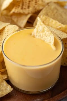 a bowl of cheese dip with tortilla chips