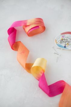 some pink, orange and yellow streamers on a table