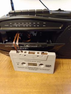 an old radio sitting on top of a wooden table