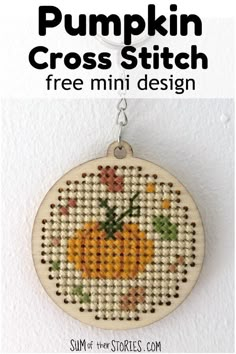 a cross stitch pumpkin ornament hanging from a hook with the words pumpkin cross stitch free mini design