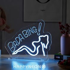 a neon sign that says racing on it next to some fruit and a teddy bear