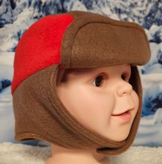 Brown and Red Accent Children's Winter Hat This hat is right on trend with today's fashion for children. It's fun, fashionable, warm and cozy and perfect to wear on a cold winter's day. The hat is made with anti pill fleece. Straps close with velcro.  -Perfect cold weather fashion accessory to keep you warm cozy and stylish -This hat will be a perfect cold weather accessory for any cold outdoor. -For all occasions and three seasons - winter spring and fall. This hat is soft and comfortable for a Red Warm Outdoor Hat, Warm Red Hat For Outdoor, Warm Red Outdoor Hat, Red Winter Hat For Outdoor, Playful Brown Winter Hat, Warm Red Winter Hat, Playful Warm Hats For Outdoor, Fun Adjustable Hats For Cold Weather, Playful Red Winter Hat