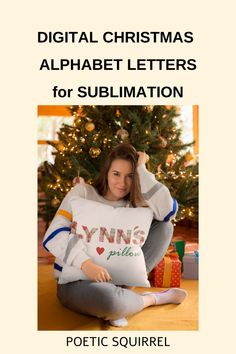 a woman sitting in front of a christmas tree holding a pillow with the words digital christmas alphabet letters for sublimation