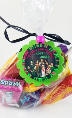 an assortment of candy wrapped in cellophane and tied to a string with a tag that says, i love josie