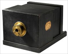 an old fashioned black box with gold trimmings and a keyhole on the front