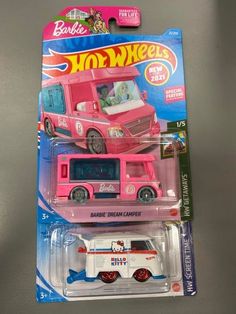 the toy bus is pink and white in color