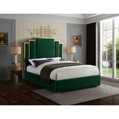 a bed with green headboard and foot board in a room next to a window