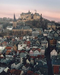 an aerial view of a city with lots of houses and buildings in the foreground