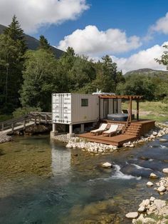 a small house sitting on top of a river next to a wooden deck and water