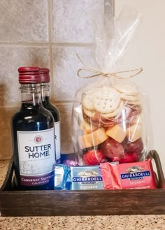 a wooden tray with cookies, crackers and wine